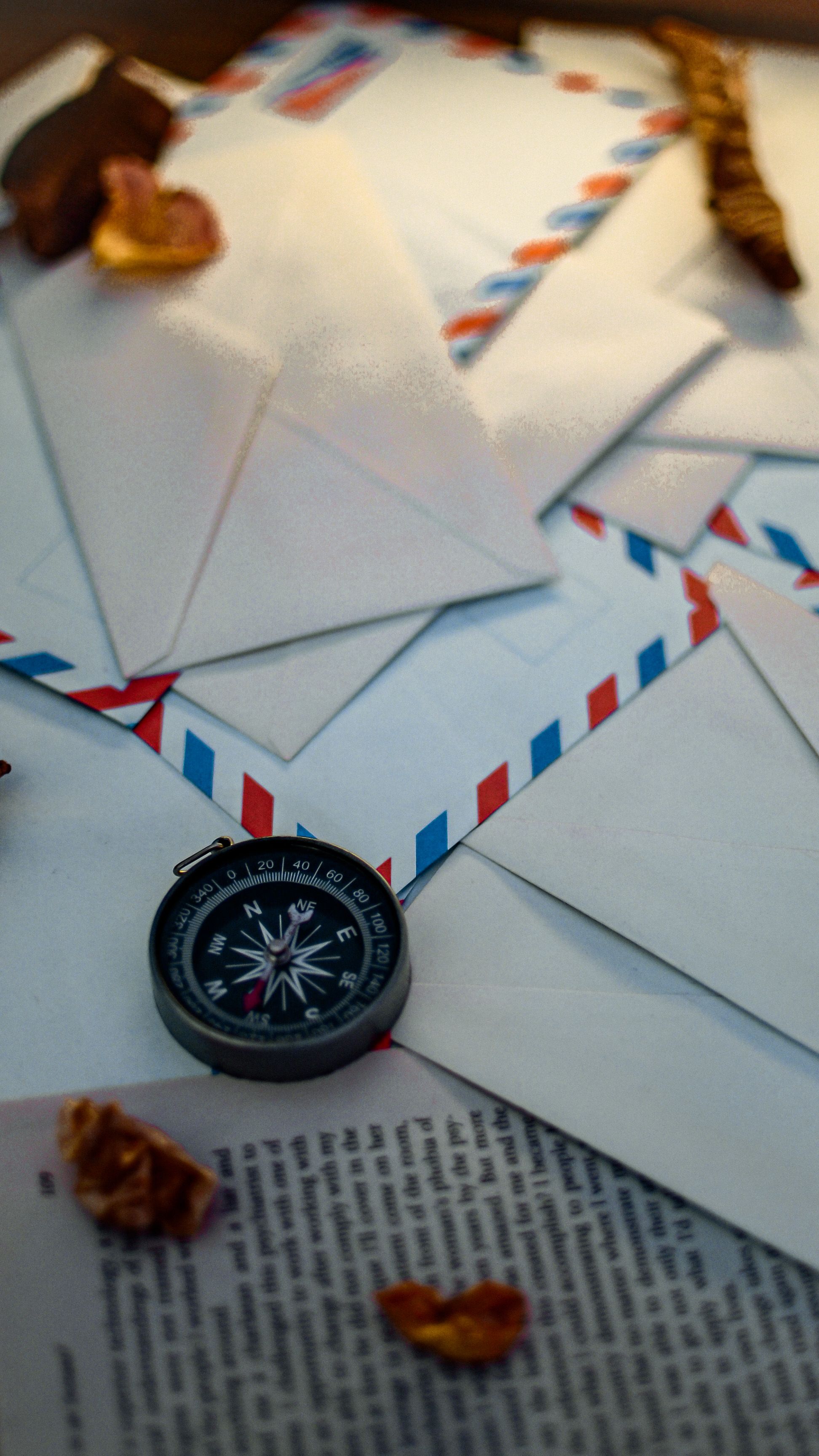 A compass and airmail materials beside a travel route